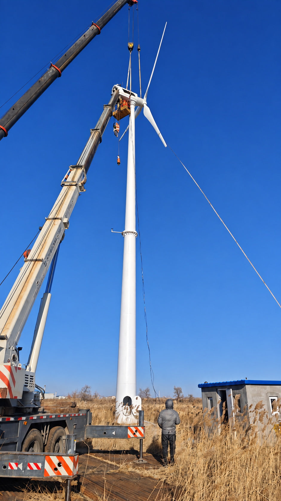 50 kW electric yaw wind turbine installation with crane at project site